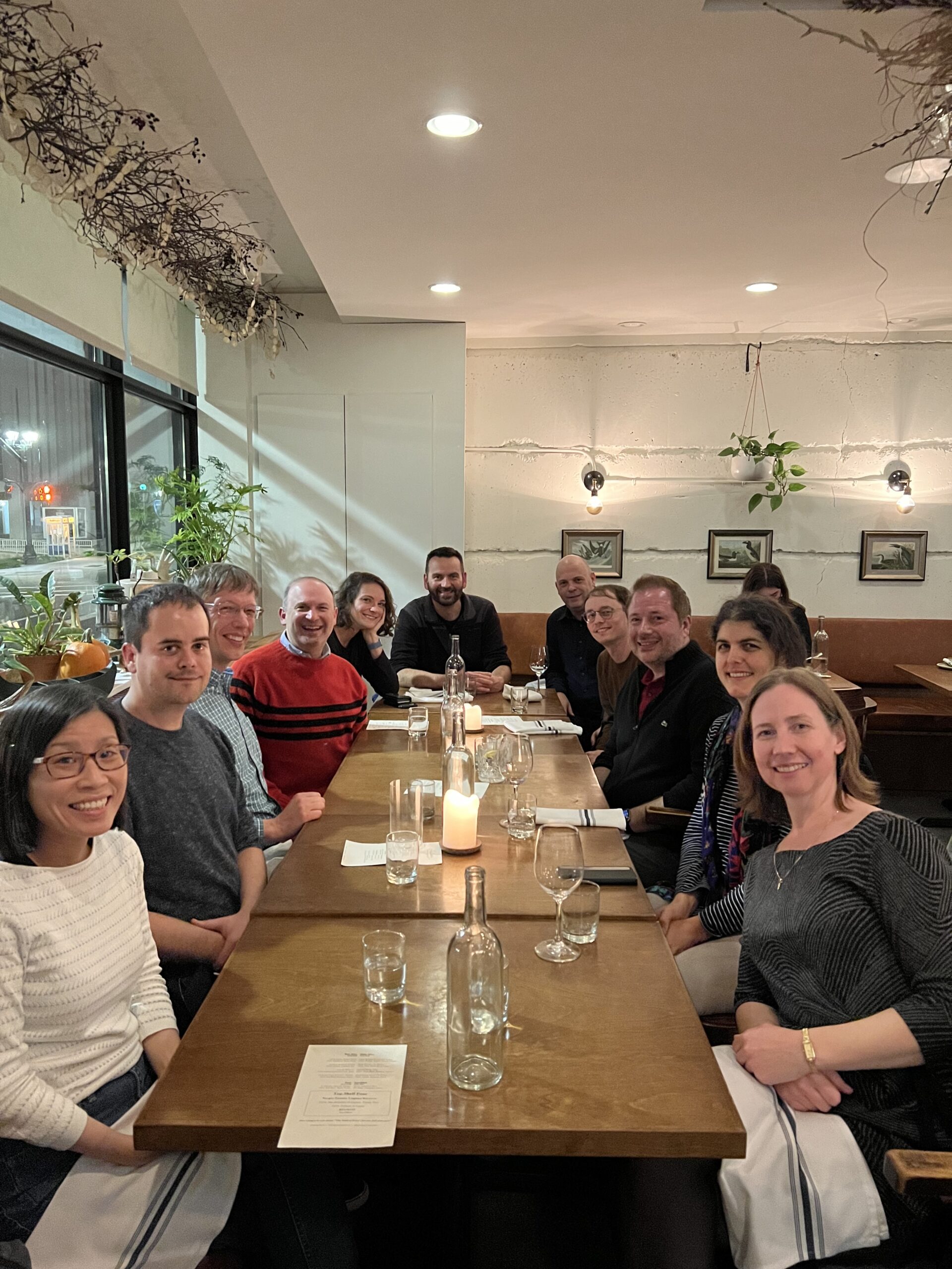 11 people around a table having dinner